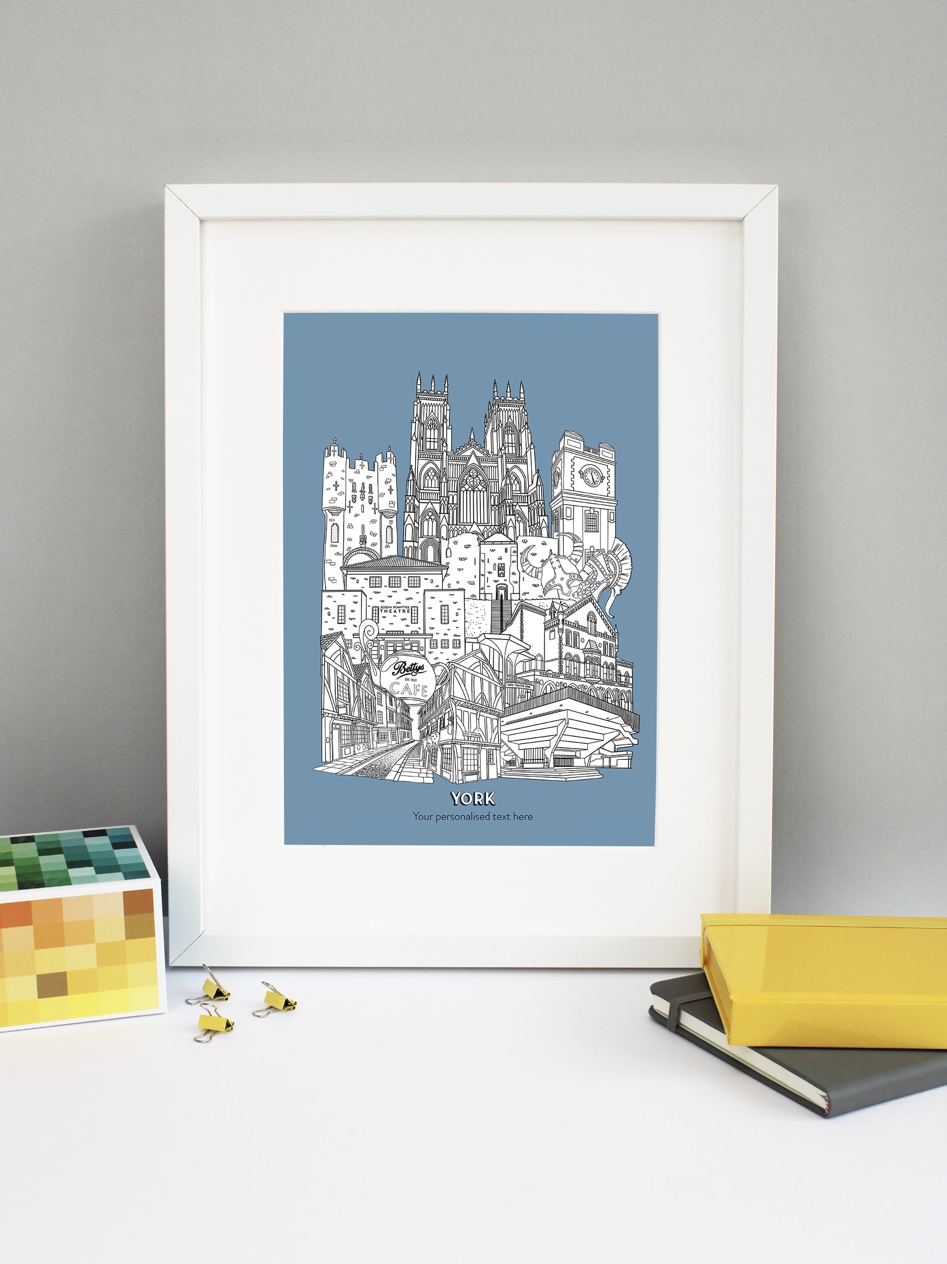 Beautifully detailed York Illustration print. The perfect gift for an engagement, wedding, birthday, anniversary and house warming. It features all the well known buildings and landmarks from the historical UK city. The buildings featured are: Bettys Tea Shop, Central Hall University, Joseph Rowntree Theatre, Micklegate Bar, Terrys Clock Tower, The Sambles, Clifford's Tower, York Theatre Royal and York Minster.